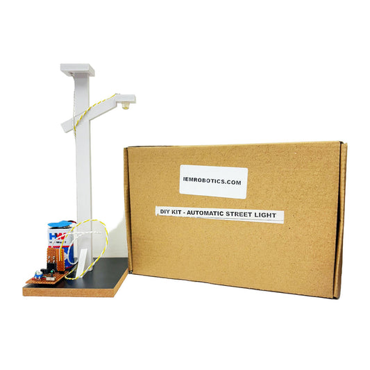 A DIY kit for an automatic street light, showcasing energy-saving technology with a model street lamp on a compact base. Perfect for practical training, it sits beside a cardboard box branded iemrobotics.com.