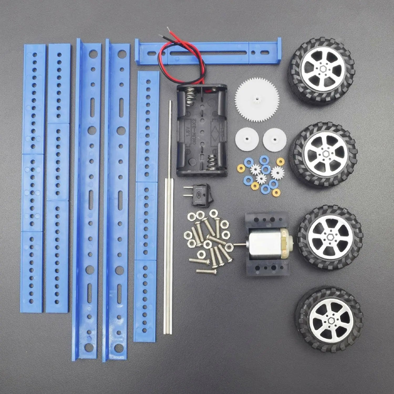 Collection of robot building components including wheels, gears, and motors on a gray background